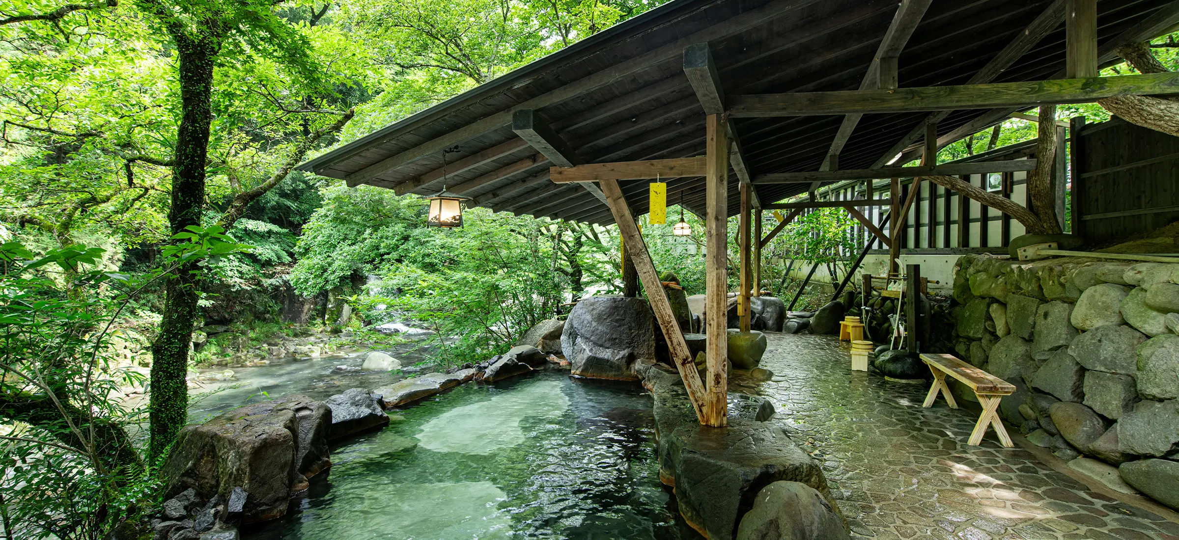 Stone open-air bath at Kotohira Onsen Yumeyama-sui beside the Takase River